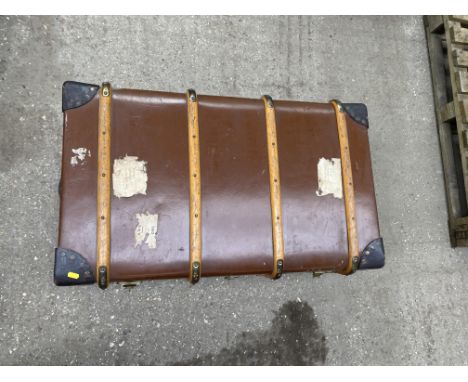 Domed top tooled leather trunk with brass lock and leather carry handles, opening to reveal lift out tray and compartment to 