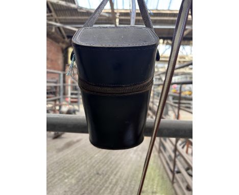 Black leather flask holder containing two glass bottles with silver tops