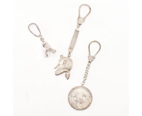 A group of three 20th Century key rings. The lot to include an Egyptian coin key ring (tests indicate silver, Egyptian silver