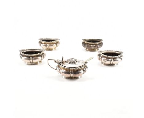 A set of five 19th Century Victorian silver hallmarked table cruets. The set to include four table salts and one lidded musta