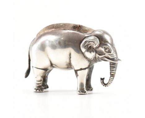 An Edwardian silver hallmarked pin cushion. The pin cushion fashioned in the form of a majestic Indian elephant, a white cush