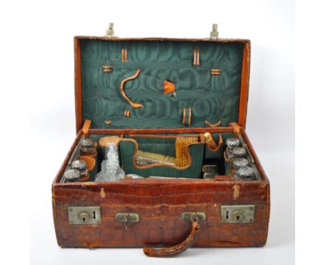 An early 20th Century Edwardian travel trunk. The trunk having a crocodile skin body and two clasps to the front. The trunk t