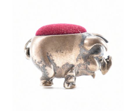 A sterling silver &amp; velvet pin cushion. The pin cushion formed in the shape of a pig. Marked 925 to the belly. Weight 11.
