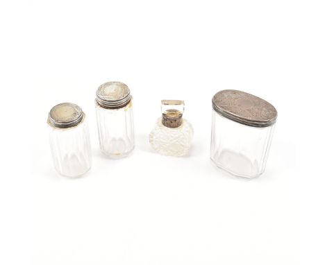 A selection of Georgian silver and glass lidded pots. Possibly condiment pots or dressing table pots.&nbsp;The pots each havi