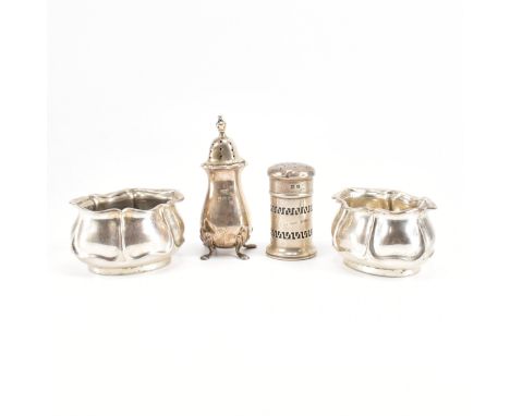 An assortment of hallmarked silver condiments. The lot to include a pair of serpentine rimmed petal design salt / mustard pot