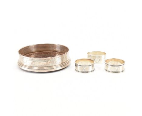 A group of four antique silver items. The lot to include three silver hallmarked napkin rings. Two napkin rings having a bead