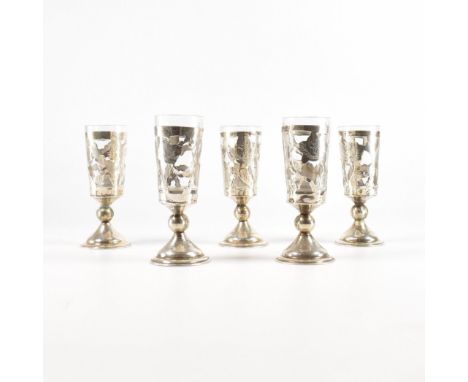 A set of five matching bud glasses.The glasses having a sterling silver case with rose detailing. Encasing a detachable glass