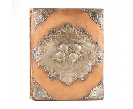 A Victorian photograph album cover. The album cover having a brown leather exterior, embellished with silver paneling to the 
