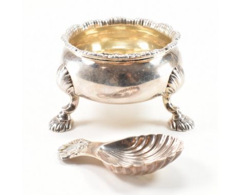 An 18th Century George III silver table salt together with a 20th Century silver caddy spoon. The Georgian table salt having 