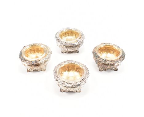 A set of four George IV hallmarked silver, gilt &amp; glass lined dishes. The bowls of squat form decorated throughout in rep