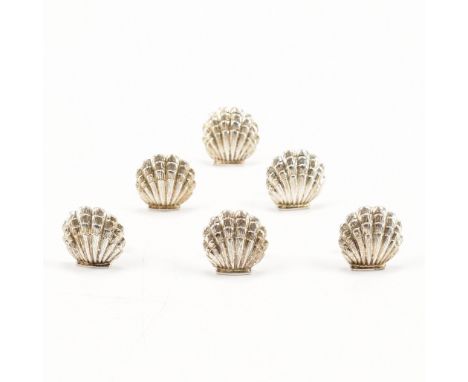 A set of six silver hallmarked card name holders. The holders having a shell form both to the front and the back. Cased. Hall