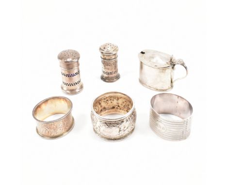 An assortment of hallmarked Victorian &amp; later silver condiments &amp; napkin rings. The lot to include; two blue glass li