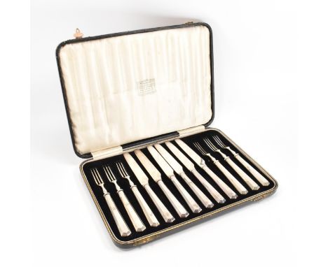A boxed set of six hallmarked silver handled knives &amp; forks. The starter knives &amp; forms having angular faceted handle