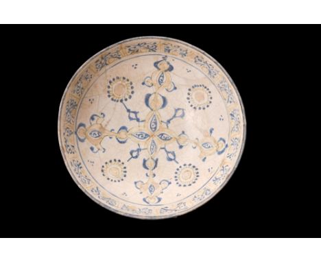 Ca. AD 1300-1400.A fritware bowl, resting on a ring foot exhibits a gradual flaring, culminating in a wide opening, which is 