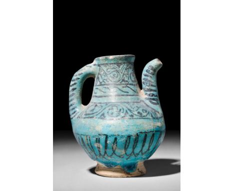 Ca. AD 1200.A turquoise-glazed light clay pitcher with a spherical lower body resting atop a flaring, unglazed base. The main