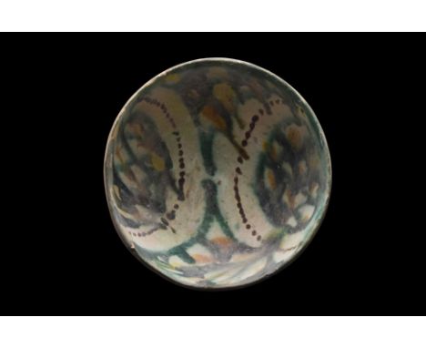 Persia, Ca. 10th century AD.A pottery bowl of a hemispherical form on a short unglazed foot. The interior is embellished with
