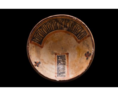Ca. 10th-11th century AD.A ceramic bowl with wide, flaring sides sitting upon a low ring foot. The interior is decorated in c