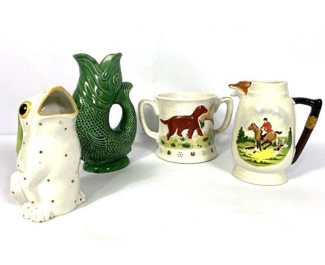 Staffordshire pottery novelty tankard, with surprise frog, the sides decorated with hunting dogs in relief, decorated in colo