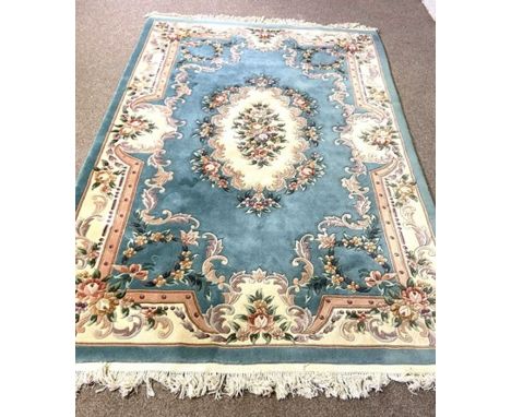 Six assorted decorative rugs, including a French style blue carpet, decorated with flowers; also a small oval pink rug, a Chi