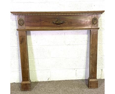 A vintage Adam style stained pine fire surround, 20th century, with dentil cornice, urn centred frieze and fluted jambs, 124c