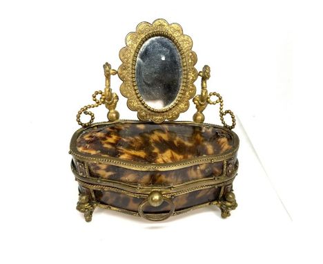 A tortoiseshell and gilt metal ladies jewelry casket, 19th century, in the form of a Bombé Dressing Table Commode