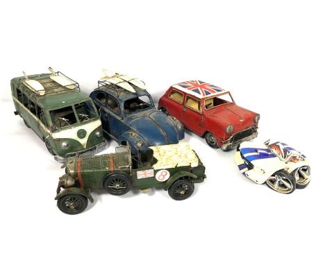 A small group of model cars, including a vintage racing green Bentley Blower; A surfer’s VW camper and beetle and other vehic