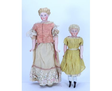 Three Parian-type shoulder head dolls, German circa 1840, each with finely painted features and blue eyes with red lines for 