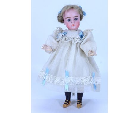 A small J.D Kestner 192 bisque head doll, German, circa 1900, with weighted blue glass eyes, closed mouth, pierced ears and l