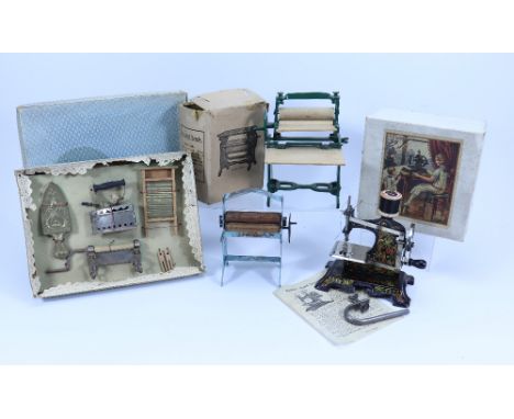 A selection of children’s kitchen and domestic toys, 1920s-50s, including a boxed German Muller’s hand sewing machine with pr