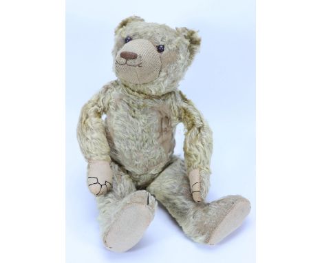 An early English mohair Teddy bear, the blonde mohair bear with black boot button eyes, replaced, cotton muzzle with stitched