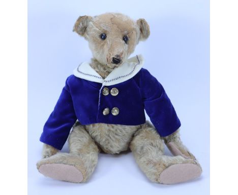 A tan mohair Steiff Teddy bear, German circa 1909, the straw filled bear with black boot button eyes, replaced black felt nos