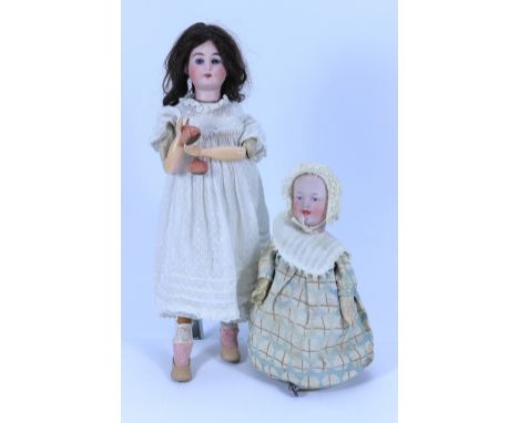 A Gebruder Heubach bisque head mechanical baby toy, German, circa 1915, with blue intaglio eyes, open/closed mouth with paint