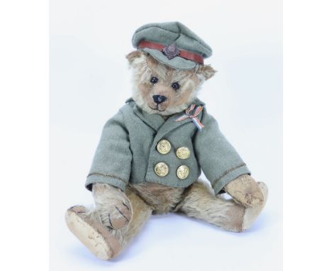 A tan mohair Steiff Teddy bear, German circa 1909, the straw filled bear with black boot button eyes, black stitched nose, mo
