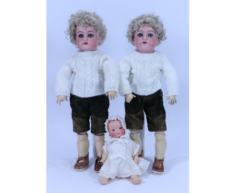 A pair of Kammer & Reinhardt twin bisque head dolls, German circa 1910, both with weighted blue glass eyes, painted lashes an