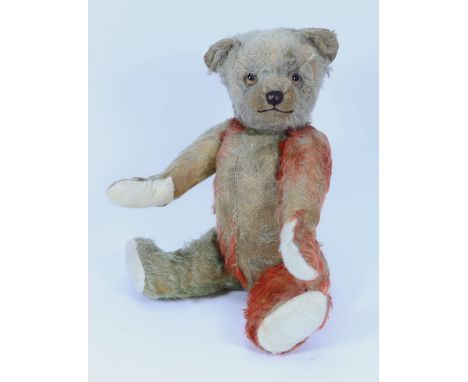 A Chad Valley blue and red mohair Coronation Teddy bear, English 1937, with amber and black glass eyes, black stitched nose, 