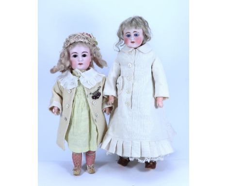A bisque shoulder head doll, German circa 1900, with weighted blue glass eyes, painted lashes and brows, open mouth with moul
