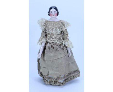 A good glazed china shoulder head doll, German circa 1840, with finely painted features and blue eyes with red line for lids,