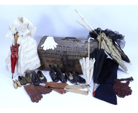 A child’s trunk with dolls accessories, including two adult and three children’s parasols, a pair of early dolls embroidered 