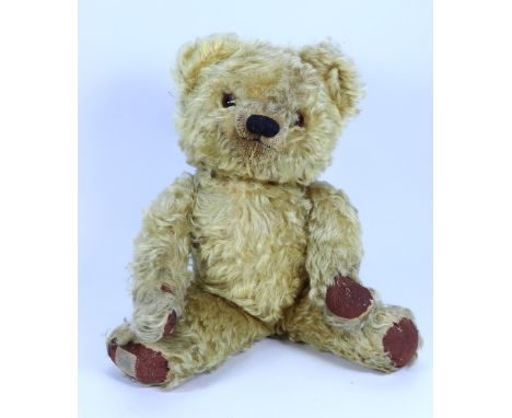 A good golden mohair Chad Valley Teddy bear, 1950s, straw and kapok filled shaggy mohair bear with red glass eyes, clipped mu