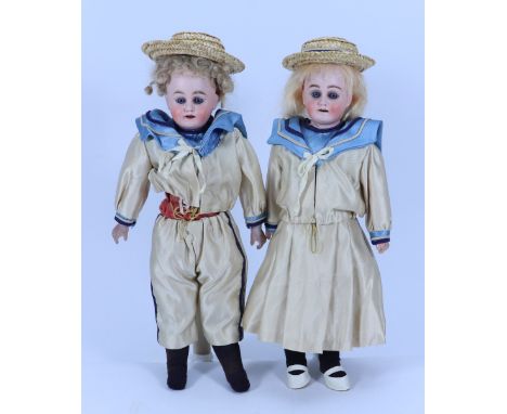 A pair of bisque shoulder head dolls,  German, circa 1910, both with weighted blue glass eyes, painted lashes, open mouth wit