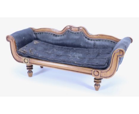 A miniature wooden Empire style sofa, circa 1870, with scrolled arms, shaped back and carved legs, upholstered in black, 4 ½”