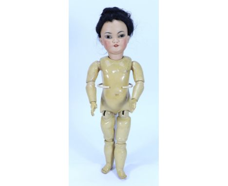 A Simon & Halbig 1199 bisque head Asian doll, German circa 1910, with weighted brown glass eyes, arched feathered brows, open