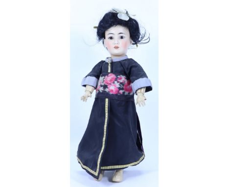 A Simon & Halbig 1329 Asian bisque head character doll, German circa 1910, with fixed brown glass eyes, painted lashes and fe