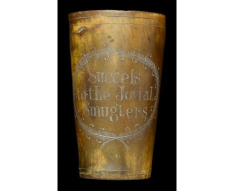 A Horn Beaker Engraved ‘Success to the Jovial Smugglers’. An interesting example about 4ins high, horn quite dark, horn base,