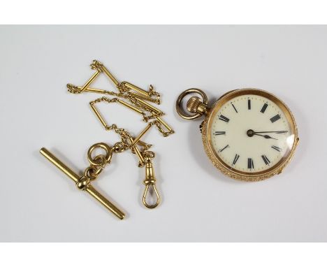 18ct Continental yellow gold lady's watch and fob, the watch having a floral engraved case with white enamel face with numeri
