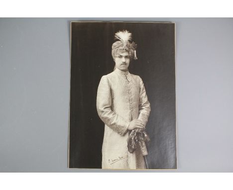 Indian Interest - a formal portrait photograph of a young Maharajah beautifully dressed in a silk gown with pearls, diamonds 