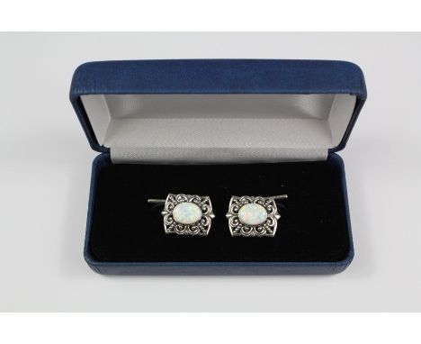 A pair of silver and opal cufflinks, filigree design, approx 9.8 gms.&nbsp;