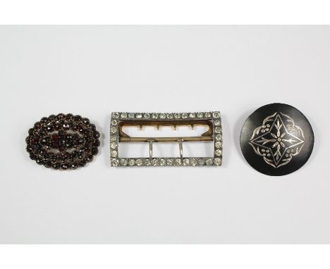 Antique garnet and yellow metal brooch, approx 25 x 38mm and 6.8 gms together with an antique silver and white stone buckle, 