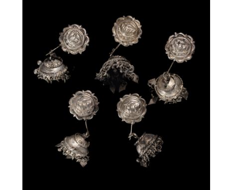 FIVE SILVER ALLOY EAR ORNAMENTS, INDONESIA, 19TH CENTURY each with earplug faced with repousse roundel decorated with lotus a