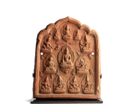 A BUDDHIST DEVOTIONAL RELIEF PLAQUE (TSA-TSA), TIBET, PROBABLY 17TH/18TH CENTURY of cusped arched form, the central figure of